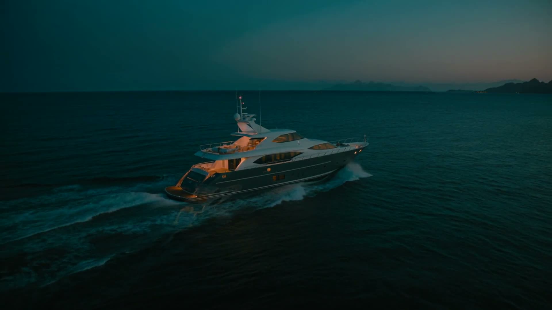 Aerial view of a private superyacht at blue hour