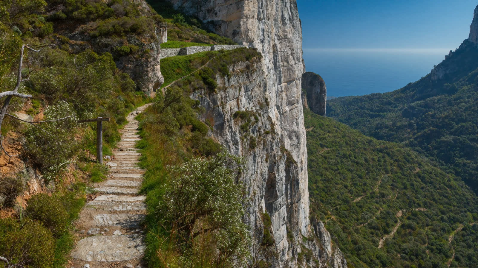 The Path of the Gods cliff trail above the Amalfi Coast with Capri on the horizon