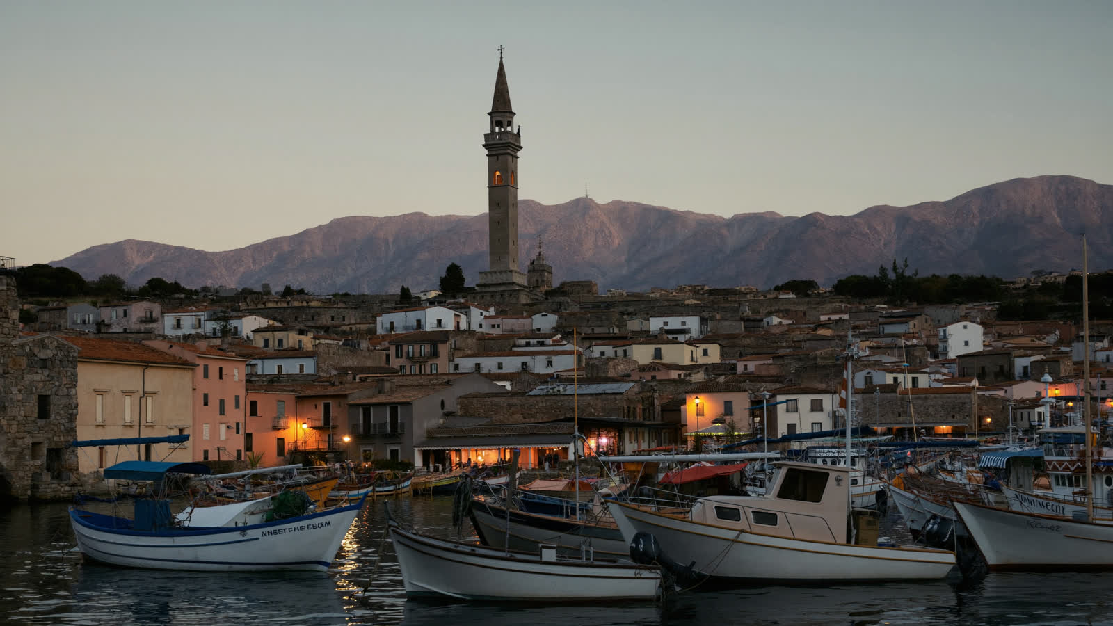Antalya's Kaleici old harbour at dusk with the Taurus mountains beyond
