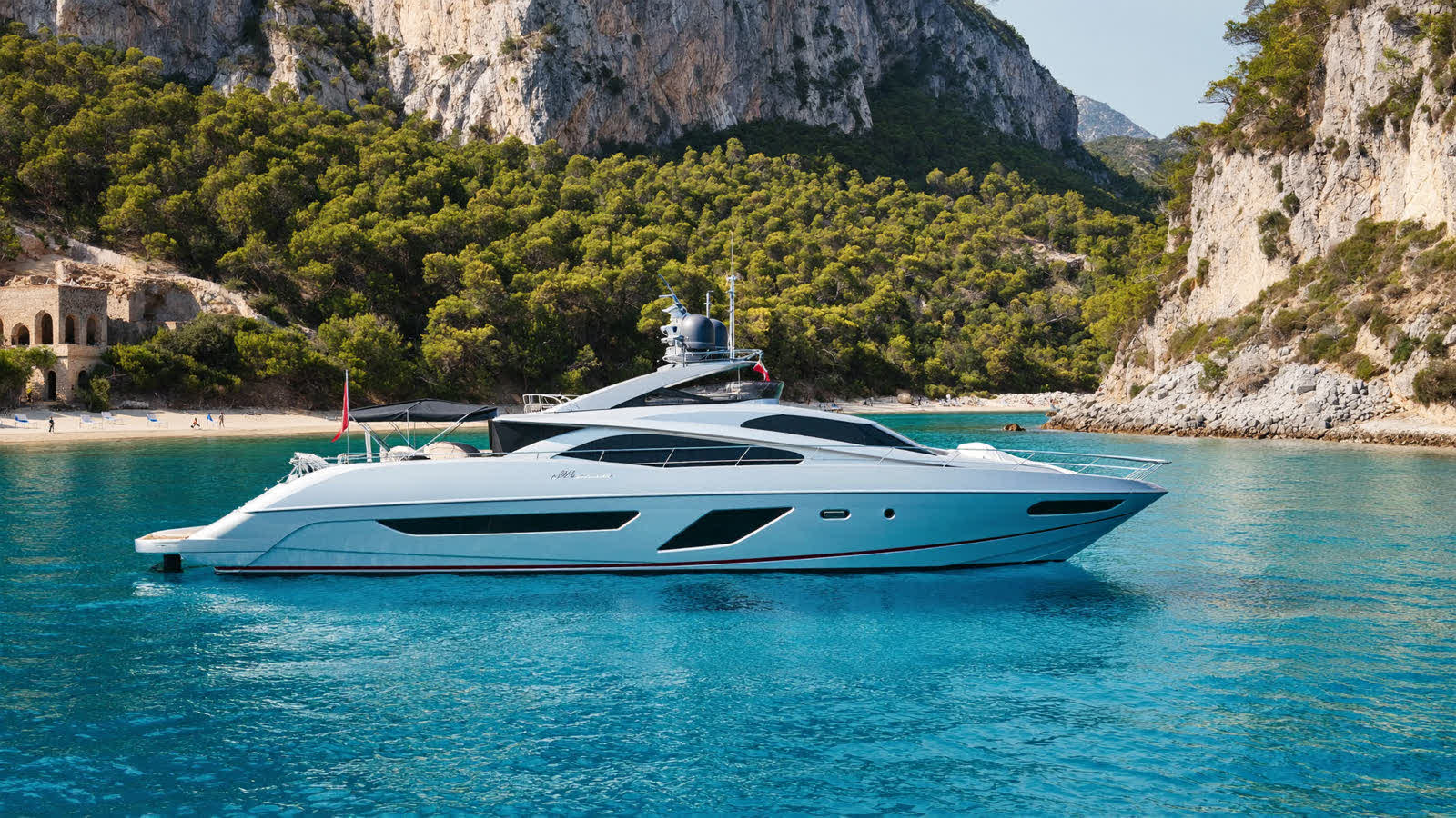 A private motor yacht at anchor in a turquoise cove on Turkey's Turquoise Coast near Antalya