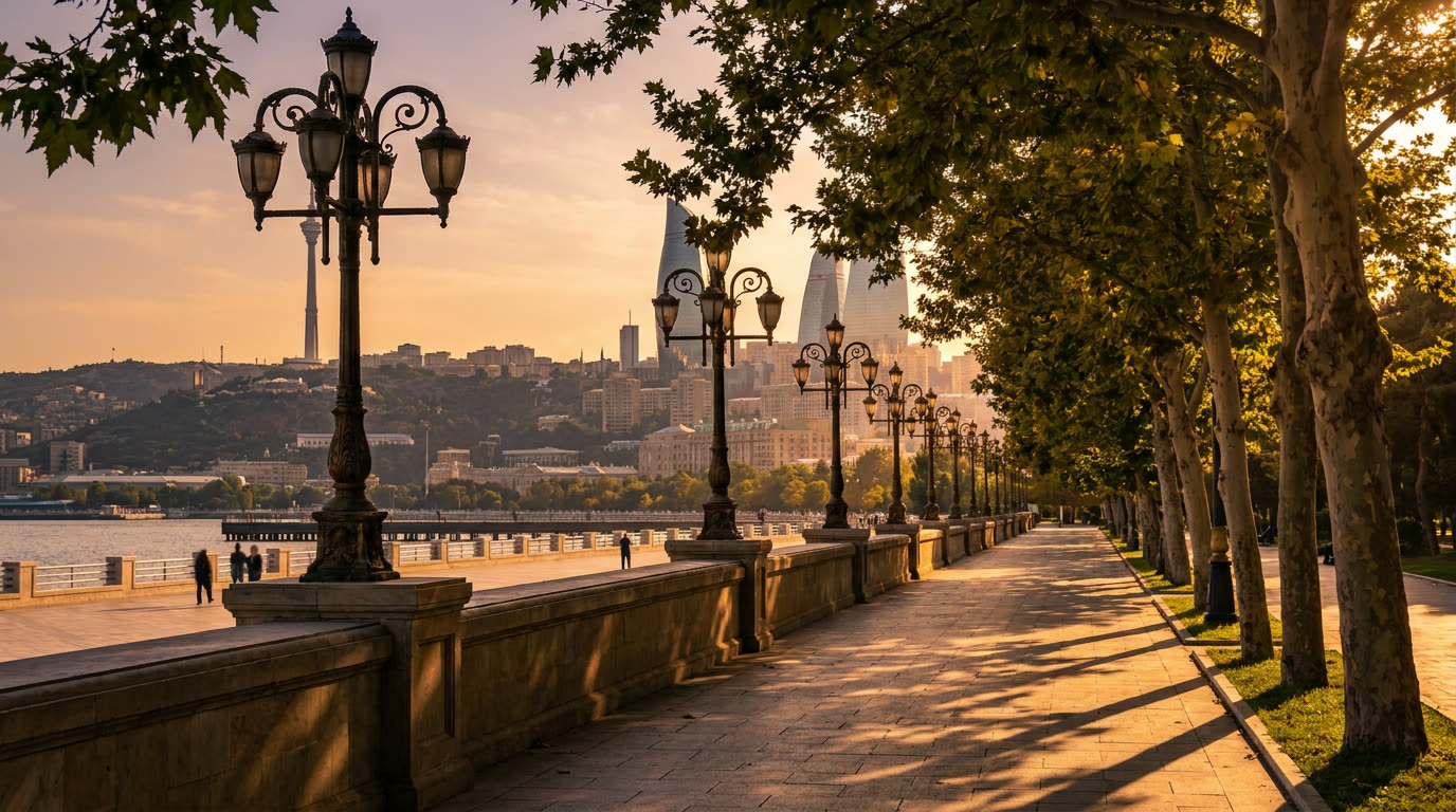 Tree-lined Baku Boulevard promenade along the Caspian bay at golden hour