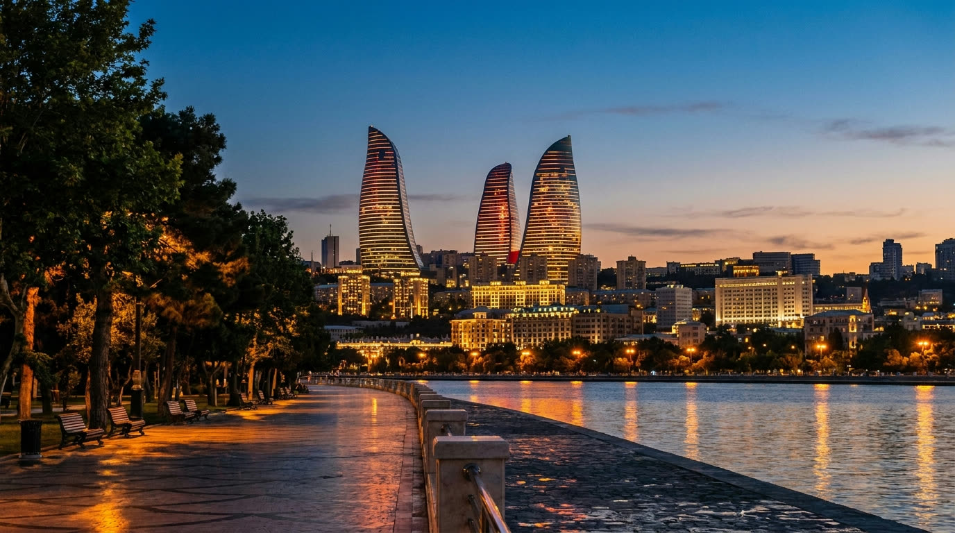 Baku skyline at dusk with the Flame Towers rising above the Caspian seafront boulevard