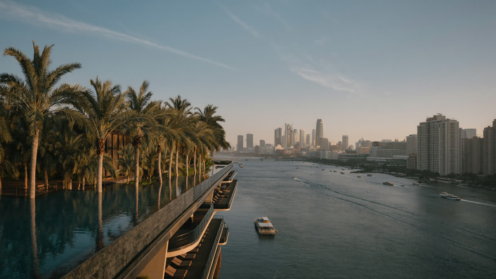 Riverside luxury hotel terrace on the Chao Phraya at golden hour, Bangkok