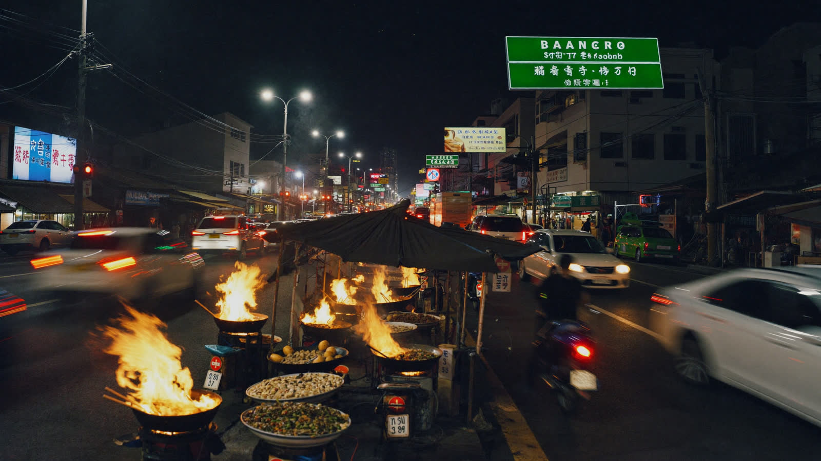 Yaowarat Road night market with neon signs and flaming woks, Bangkok Chinatown