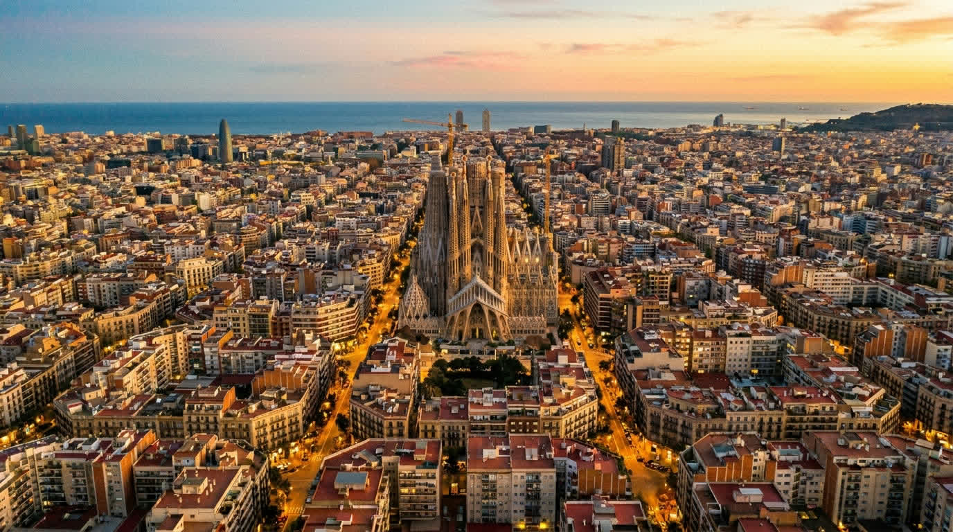 Aerial view of Barcelona's Eixample grid with the Sagrada Família at golden hour