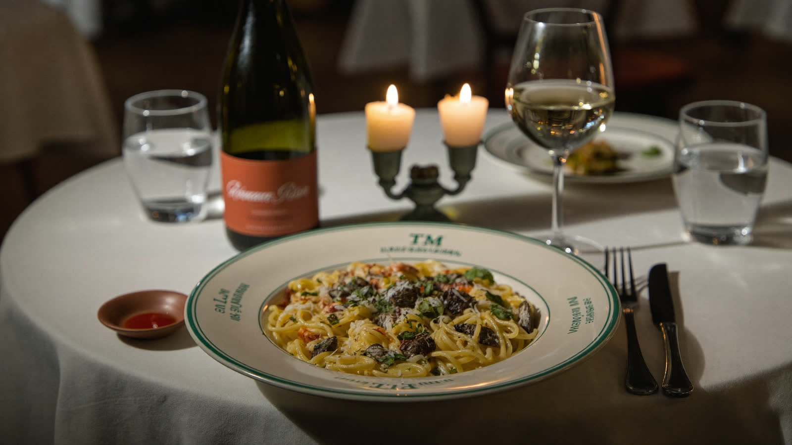 Cacio e pepe with wine on a candlelit trattoria table, Rome